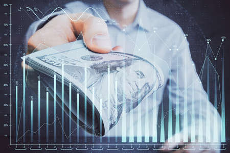 Multi exposure of financial graph drawing hologram and USA dollars bills and man hands. Analysis...