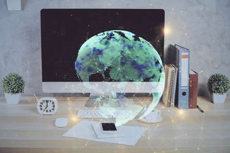 Computer on desktop with social network hologram. Double exposure. Concept of international people connections.の写真素材