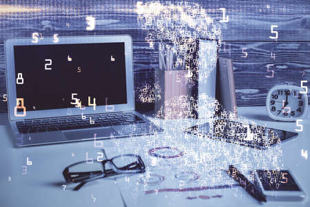 Computer on desktop in office with technology theme hologram. Double exposure. Tech concept.