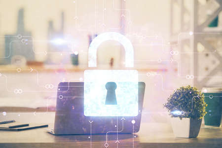 Double exposure of desktop with computer and lock icon hologram. Concept of data safety.の写真素材