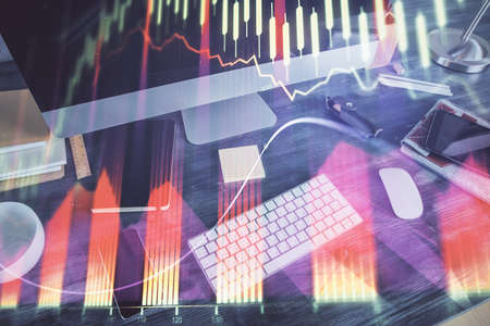 Double exposure of chart and financial info and work space with computer background. Concept of...