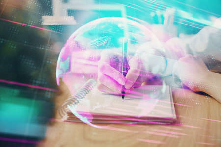 Tech theme hologram over womans hands taking notes background. Concept of hightech. Double exposureの写真素材