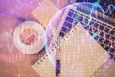 Double exposure of forex chart drawing over table background with computer. Concept of financial research and analysis. Top view.の写真素材