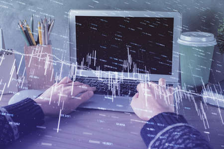Double exposure of woman hands typing on computer and forex chart hologram drawing. Stock market...