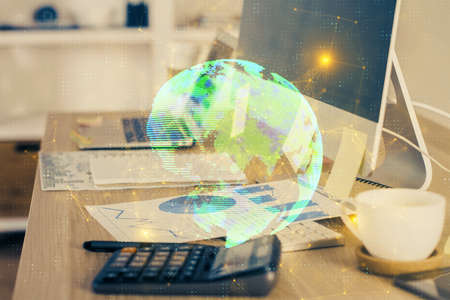Computer on desktop with social network hologram. Multi exposure. Concept of international people connections.の写真素材