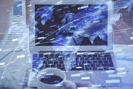 Double exposure of laptop computer and technology theme hologram. Concept of freelance work.の写真素材