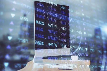 Financial chart drawing and table with computer on background. Multi exposure. Concept of...
