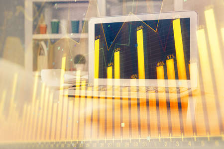 Stock market chart hologram drawn on personal computer background. Multi exposure. Concept of...