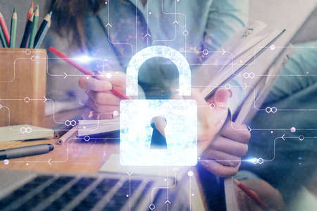 Multi exposure of womans hands making notes with lock icon. Concept of security and protection of dataの写真素材
