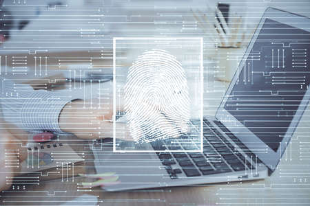 Fingerprint hologram with businessman working on computer on background. Security concept. Double exposure.の写真素材