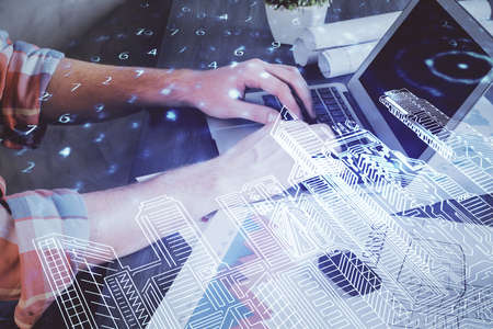 High tech city drawing with businessman working on computer on background. Smartcity concept. Double...