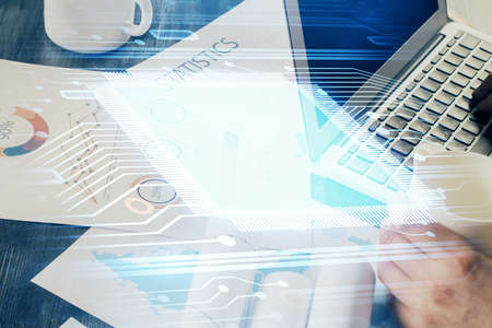 Multi exposure of technology hologram with man working on computer background. Concept of big data.