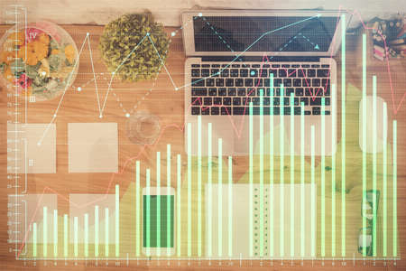 Stock market graph and top view computer on the table background. Multi exposure. Concept of financial education.の写真素材
