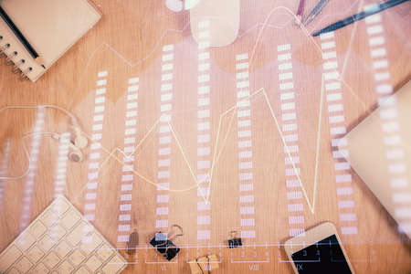 Multi exposure of forex graph hologram over desktop with phone. Top view. Mobile trade platform...