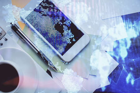 Multi exposure of forex graph hologram over desktop with phone. Top view. Mobile trade platform concept.の写真素材