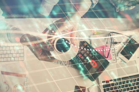 Double exposure of man and woman working together and financial chart hologram drawing. market...