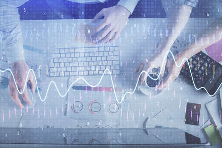 Double exposure of man and woman working together and financial chart hologram drawing. market...
