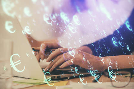Multi exposure of woman hands typing on computer and financial graph hologram drawing. Stock market...