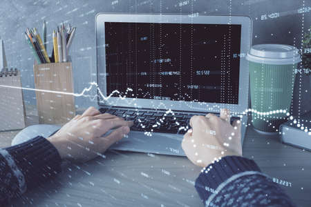 Double exposure of woman hands typing on computer and forex chart hologram drawing. Stock market...