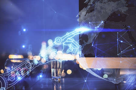 Computer on desktop in office with technology theme hologram. Double exposure. Tech concept.の写真素材