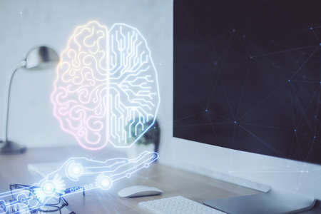 Double exposure of work space with computer and human brain drawing hologram. Brainstorm concept.