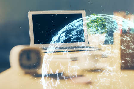 Computer on desktop with social network hologram. Multi exposure. Concept of international people connections.の写真素材