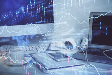 Forex market graph hologram and personal computer on background. Double exposure. Concept of...