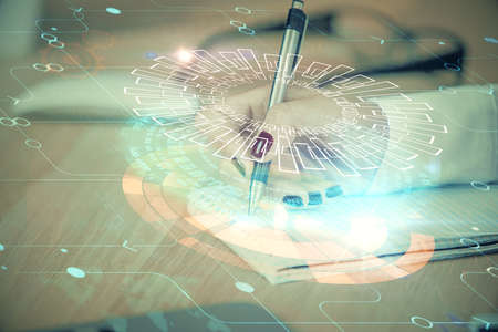 Multi exposure of womans writing hand on background with data technology hud. Concept of innovation.の写真素材