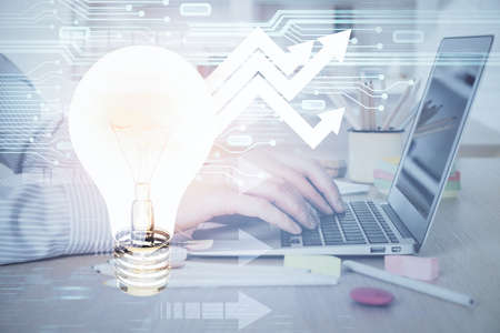Growing arrows with businessman working on computer on background. Success concept. Double exposure.の写真素材