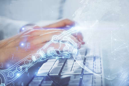 Technology theme hologram with man working on computer on background. High tech concept. Multi...