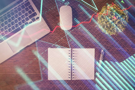 Stock market graph and top view computer on the table background. Double exposure. Concept of...