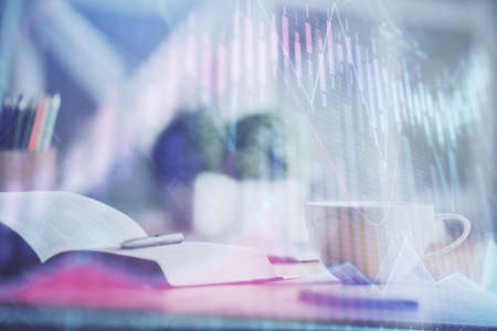 Multi exposure of forex graph drawing and desktop with coffee and items on table background. Concept...