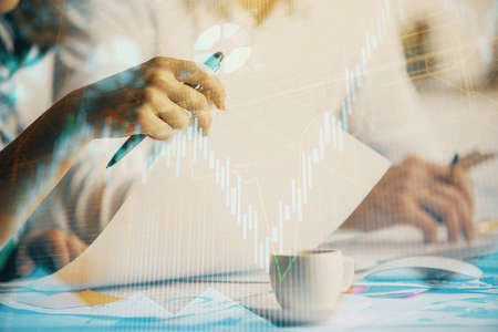 Double exposure of forex graph drawing over people taking notes background. Concept of financial...