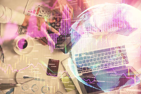Double exposure of man and woman working together and financial chart hologram drawing. market...
