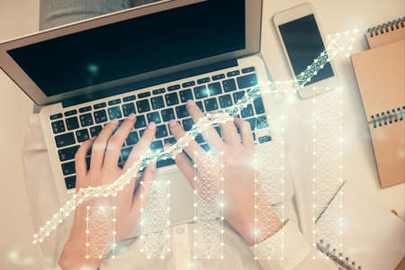 Double exposure of woman hands working on computer and forex chart hologram drawing. Top View....
