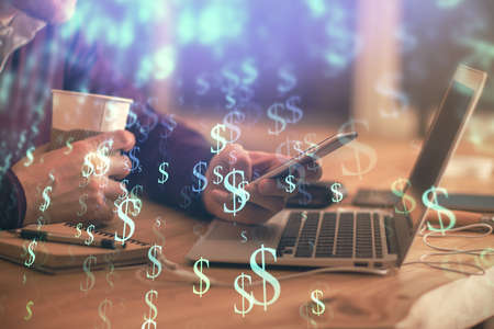 Double exposure of mans hands holding and using a phone and financial graph drawing. Analysis...