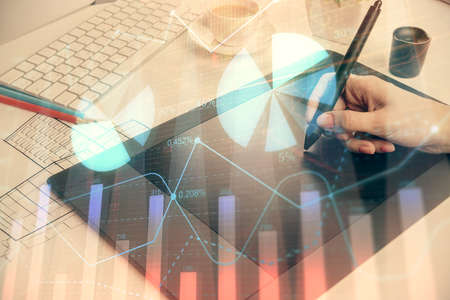 Double exposure of financial graph sketch hologram and woman holding and using a mobile device....