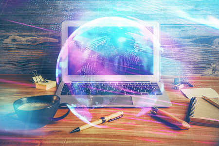 Computer on desktop in office with technology theme hologram. Double exposure. Tech concept.の写真素材