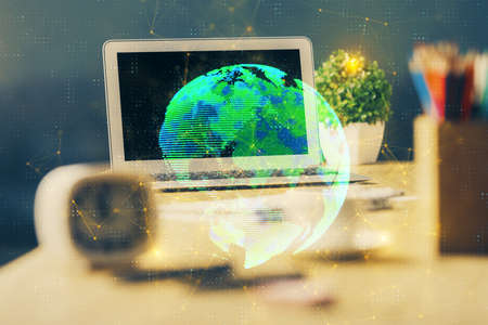 Computer on desktop with social network hologram. Multi exposure. Concept of international people connections.の写真素材