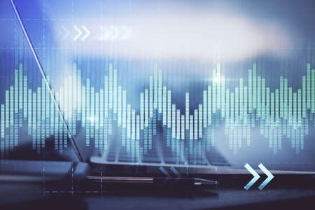 Forex Chart hologram on table with computer background. Multi exposure. Concept of financial markets.の写真素材