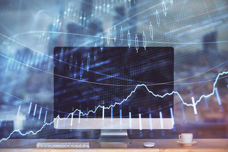 Stock market chart hologram drawn on personal computer background. Multi exposure. Concept of...