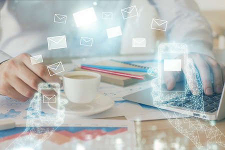 Envelop holograms with businessman working on computer on background. E-mail concept. Multi...