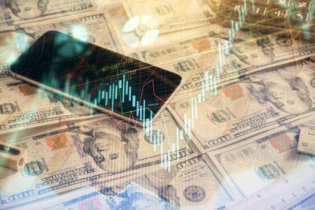 Double exposure of forex graph drawing over us dollars bill background. Concept of financial...