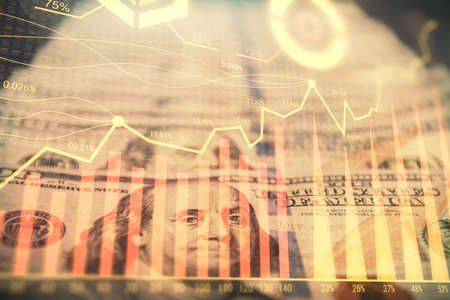 Double exposure of forex graph drawing over us dollars bill background. Concept of financial...