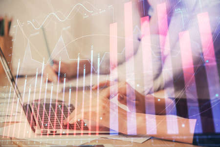 Multi exposure of woman hands typing on computer and financial chart hologram drawing. Stock market analysis concept.の写真素材