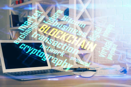 Double exposure of blockchain theme hologram and table with computer background. Concept of bitcoin...