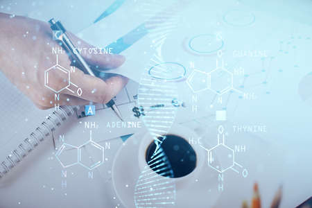 Mans hands working with notes background. Genetic engineering and gene manipulation concept. Multi...