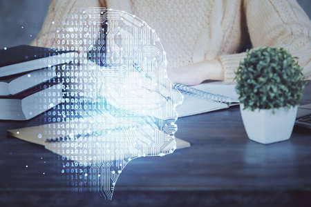 Multi exposure of writing hand on background with brain hologram. Concept of learning.