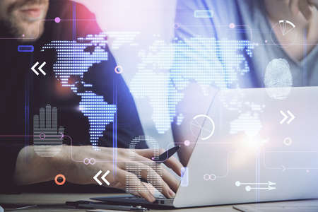 Double exposure of world map hologram with man working on computer on background. Concept of...