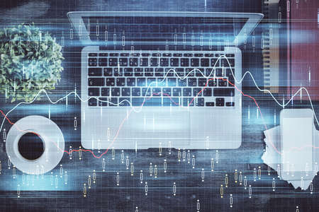 Stock market chart and top view computer on the table background. Double exposure. Concept of...